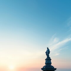 Statue against a serene, colorful sunset sky, capturing tranquility and artistic beauty in a stunning landscape.