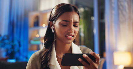 Phone, earphones and frustrated girl with online game, live stream or fake news on social media....