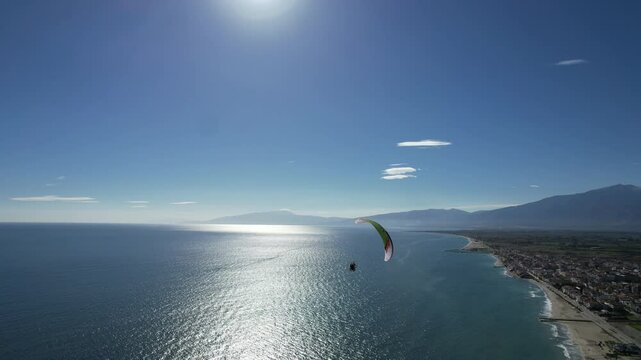 Powered paragliding in Greece near Meteora on the coast line over beautiful sandy beaches, paramotor flying in a see breeze,aerial panorama landscape view of Greek nature,outdoor concept