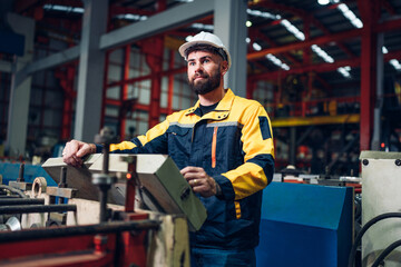 Industrial man engineer wear uniform working and checking system machine at factory. Workers industrial factory. Machine maintenance technician operation concept.