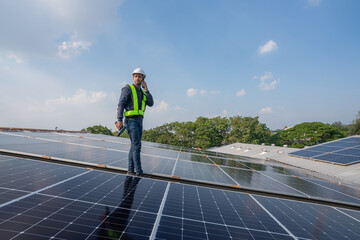 Service Engineer use tablet working inspection installation solar cell on the roof. Technician maintenance solar cells on roof factory. Technology solar energy renewable.