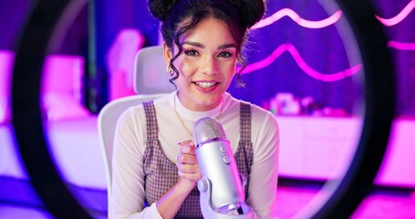 Ring light, home and girl live streaming or talking on microphone for social media followers in neon bedroom. Face of streamer, gamer or content creator recording update of game release in POV screen © CineLens2024/peopleimages.com