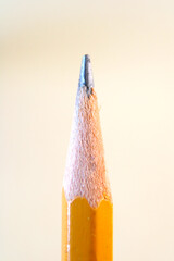 The tip of a sharpened graphite pencil close up. Vertical photo