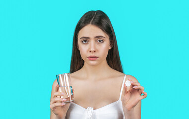 Woman taking drugs to releave headache. Woman taking pill against headache. Brunette take some...