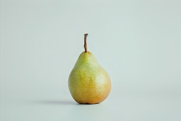 Single pear in front of pale green background