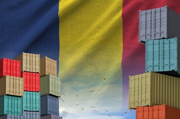 Chad flag and big stack of shipping cargo containers in docks with sky background close up