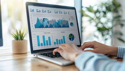 A person is using a keyboard attached to a laptop to display a graph on the screen