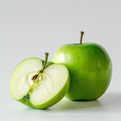 Close-up of a green apple sliced to reveal the juicy flesh, positioned beside a full green apple on a light surface, highlighting freshness and texture.