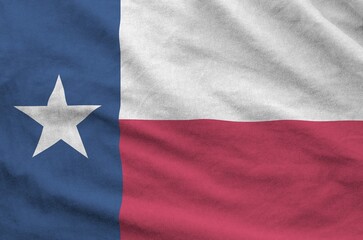 Texas US state flag depicted on folded wavy fabric of old cloth close up