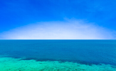 Obraz premium Nature of the beach and sea Summer with sunshine, sandy beaches, clear blue waters sparkling against the blue sky. On an island with good ecology and environment Background for summer vacation concept