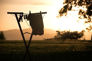 T-shirt is dried on a drying rack at sunset
