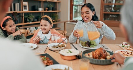 Juice, dinner and family in dining room for eating together at home with roast meal for nutrition. Happy, bonding and mother pour fruit drink or beverage for kids at supper in house with conversation
