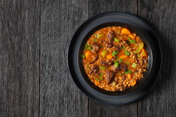 beef barley soup in a bowl, top view