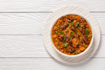 beef barley soup in a bowl, top view