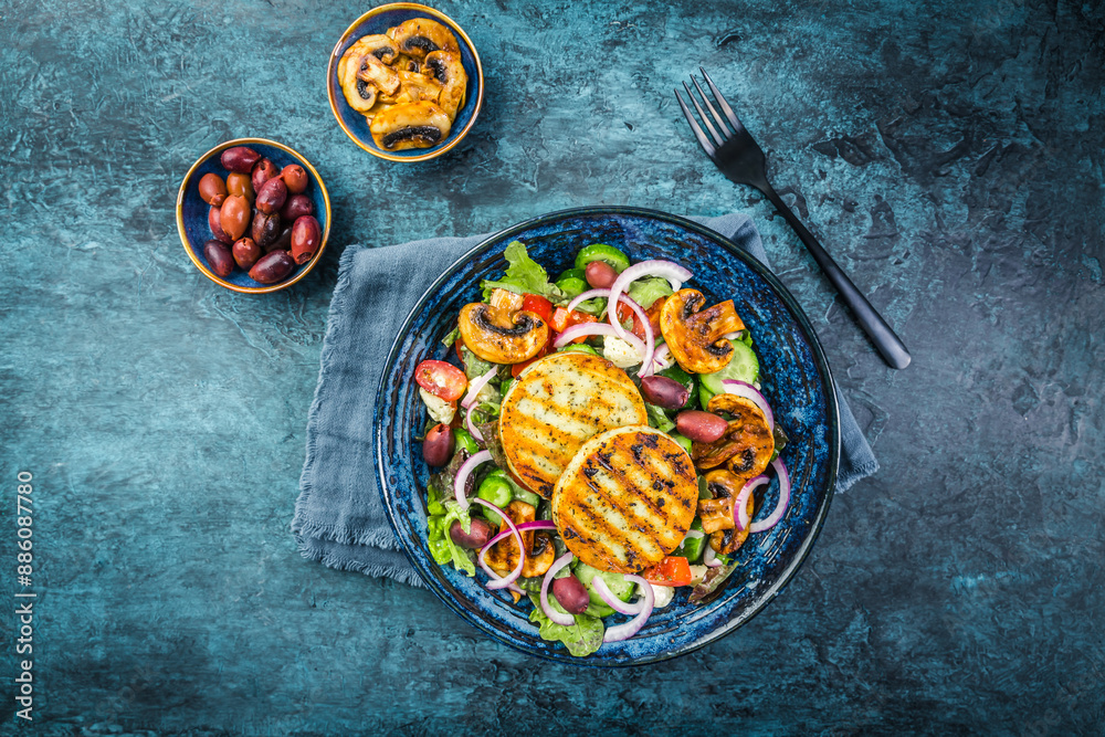 Poster fresh salad with grilled cheese, tomatoes, lettuce, grilled champignons, cucumber and olives