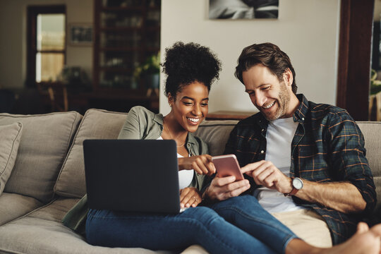 Couple, relax and happy with technology on sofa for social media, streaming subscription and online shopping for apartment. Man, woman and together in home with laptop or smartphone for connectivity.