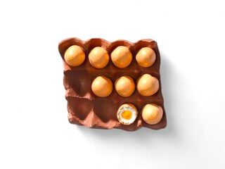 miniature eggs on a paper shelf on a white background