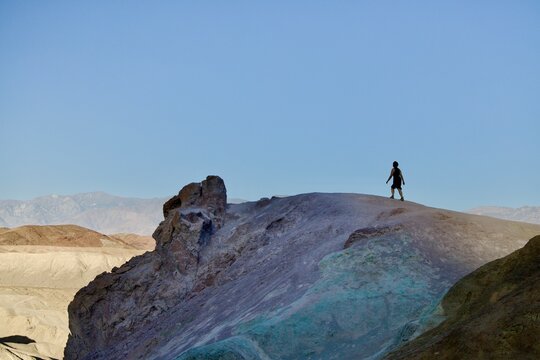 solo woman in black dress hikes in dath valley national park, california