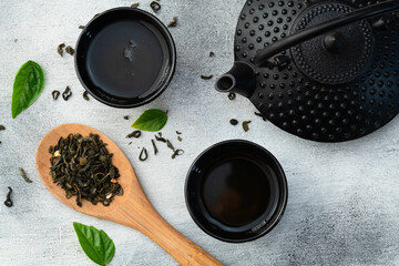 Green Tea with japanese teapot and leaves