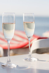 Two glasses of wine on the beach.
