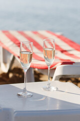 Two glasses of wine on the beach.