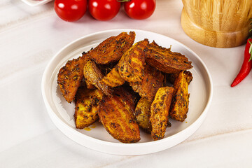 Golden baked potato Idaho with spices