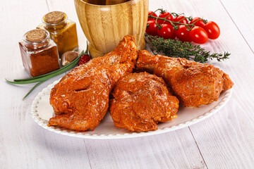 Raw turkey shoulder wing in Indian tandoori marinade