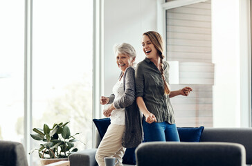 Dancing, mature woman and daughter with celebration in house, movement and time together. Family,...