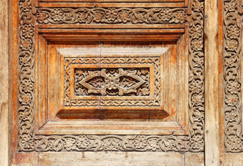 Texture of vintage wood boards with carved decorative border. Vertical or horizontal retro background with old wooden planks and floral ornamen