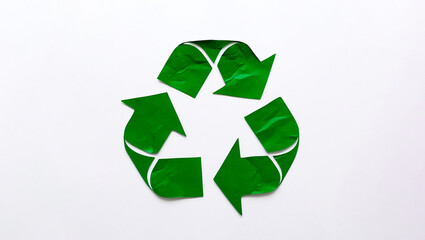 Obraz premium Recycling symbol made of green paper, Green paper cutout of a recycling symbol, Recycling icon isolated in a white background