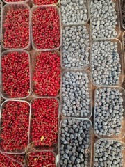 blueberries and raspberries lie on store shelves