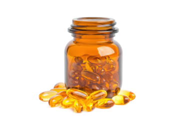 An amber glass bottle filled with fish oil softgel capsules, with additional capsules scattered around the base. The capsules are golden and translucent, showcasing their omega-3 content