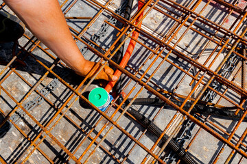 Technician is adjust corrugated pipes and mount them to junction box