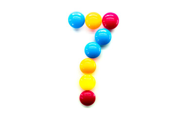 Digit 7 of multicolored rainbow candies isolated on white background. alphabet and numbers