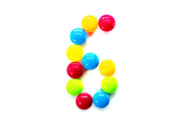 Digit 6 of multicolored rainbow candies isolated on white background. alphabet and numbers