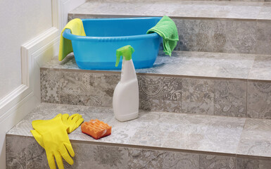 Household cleaning products and items for cleaning tile stair tile in house. Cleaning and...
