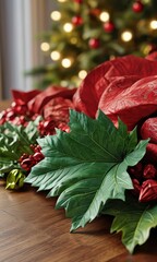 Green Leaf and Red Ornaments on Wooden Table.