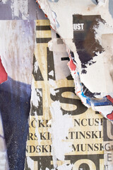 Fototapeta premium Ripped and torn old street poster background, messy and grungy paper collage backdrop