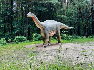 Vulcanodon dinosaur. Realistic figure of the Vulcanodon dinosaur in the forest in Kazimierz, Sosnowiec. The park setting highlights the dinosaur in its natural environment. © Chawran