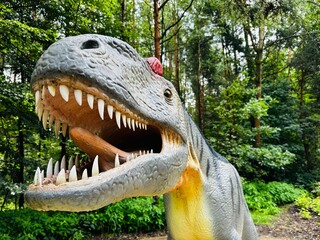 Allosaurus dinosaur. Realistic figure of an Allosaurus dinosaur inforest park in Kazimierz Sosnowiec. Prehistoric predator create a fascinating element of the landscape, attracting dinosaur lovers. © Chawran