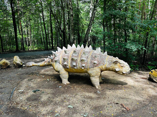 Sajchania dinosaur. Realistic figure of an Sajchania dinosaur inforest park in Kazimierz Sosnowiec. Prehistoric predator create a fascinating element of the landscape, attracting dinosaur lovers. © Chawran