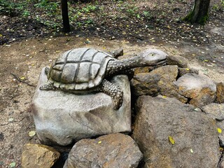 Realistic figure of an Turtle dinosaur inforest park in Kazimierz Sosnowiec. Prehistoric predator create a fascinating element of the landscape, attracting dinosaur lovers. Turtle dinosaur. © Chawran