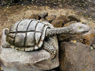 Realistic figure of an Turtle dinosaur inforest park in Kazimierz Sosnowiec. Prehistoric predator create a fascinating element of the landscape, attracting dinosaur lovers. Turtle dinosaur. © Chawran
