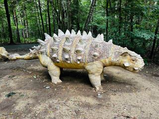 Sajchania dinosaur. Realistic figure of an Sajchania dinosaur inforest park in Kazimierz Sosnowiec. Prehistoric predator create a fascinating element of the landscape, attracting dinosaur lovers. © Chawran