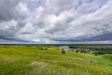A cloudy sky with a river in the background