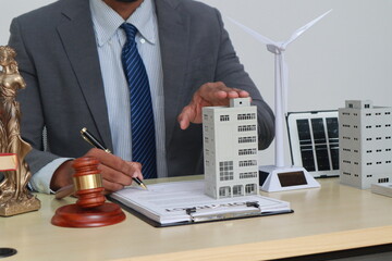 A businessman in a suit sits at a table discussing the Clean Energy Act, which incentivizes...