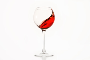 Diagonal wave of rose wine, alcohol is in glass on white isolated.