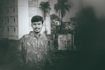 Picture of a Male Model posing outdoor.  Man posing in creative lighting.