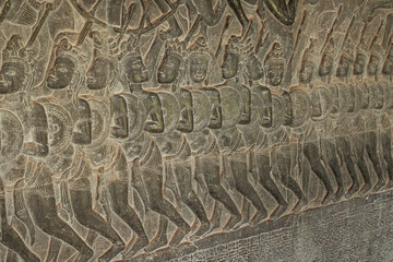 Carved bas relief detailing ancient warriors at Angkor Wat temple, Siem Reap, Cambodia.