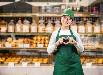 Asian seller wear green apron and green cap smiling